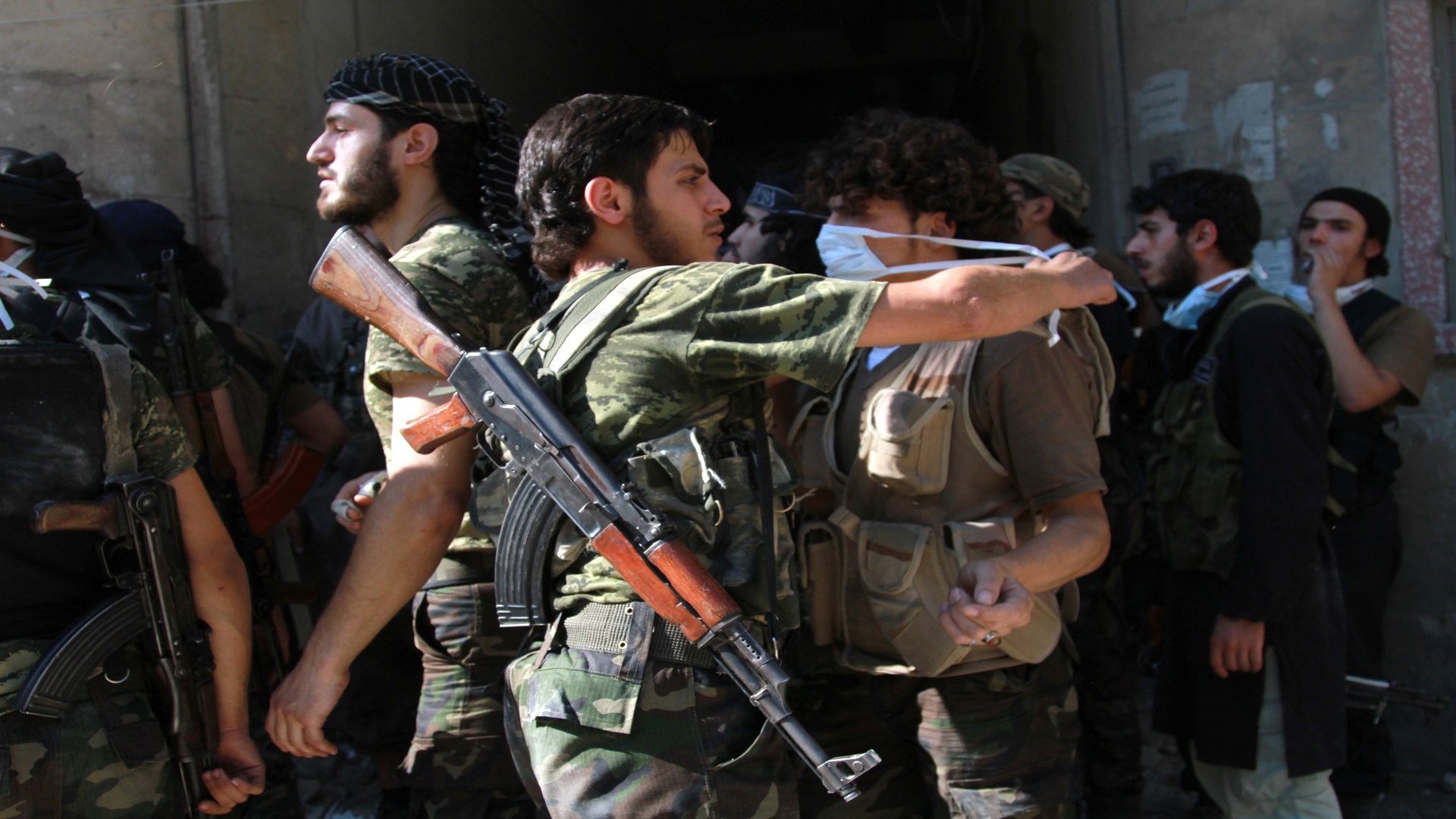 ALEPPO, SYRIA - JULY 29: Members of Islamic Front group are seen as several soldiers loyal to President Bashar al-Assad is killed after  Syrian opposition group Islamic Front's attacks on Assad forces' headquarter in opposition-controlled Aleppo, Syria on July 29, 2014. (Photo by Salih Mahmud Leyla/Anadolu Agency/Getty Images)